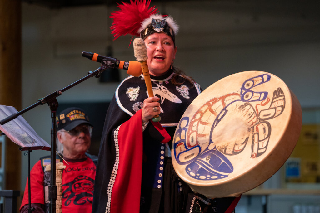 Indigenous People Festival performer holding a large brown drum.